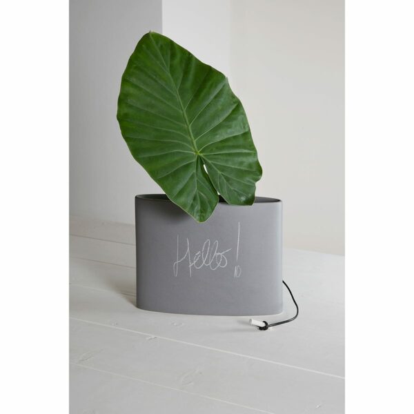 vaso in ceramica smaltato simil cemento con una grande foglia verde