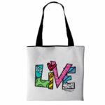 borsa di tipo tote bag in morbida ecopelle bianca con testo live stilizzato di Romero Britto